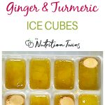 ginger turmeric ice cubes in tray with ginger slices